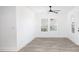 Bright, open living room featuring wood-look floors, natural light, and a modern ceiling fan at 2924 Chicora Ave, North Charleston, SC 29405