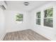 Bright living room with wood floors, white walls, and three large windows offering plenty of natural light at 2924 Chicora Ave, North Charleston, SC 29405