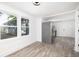 Spacious and bright room with wood floors, and a view to a kitchen and the exterior at 2924 Chicora Ave, North Charleston, SC 29405