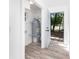 Utility room featuring a modern water heater, storage, and easy access to the outdoors at 2924 Chicora Ave, North Charleston, SC 29405