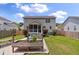 Lovely backyard featuring a deck, patio, planting bed and lush lawn at 3038 Penny Ln, Johns Island, SC 29455