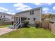 Beautiful backyard showcasing the back of the house with a patio and green lawn at 3038 Penny Ln, Johns Island, SC 29455