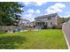 Spacious backyard with a fire pit and lounge area, perfect for outdoor entertaining at 3038 Penny Ln, Johns Island, SC 29455