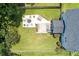 Aerial view of a backyard featuring a stone firepit, seating area and manicured lawn at 3038 Penny Ln, Johns Island, SC 29455