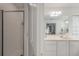 Bright bathroom with a glass enclosed shower and white vanity with a large mirror at 3038 Penny Ln, Johns Island, SC 29455