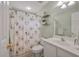 Small bathroom featuring a shower with patterned curtain, and shelving above the toilet at 3038 Penny Ln, Johns Island, SC 29455