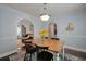 Cozy dining room featuring blue walls, dark floors, and an arched entryway at 3038 Penny Ln, Johns Island, SC 29455