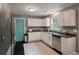 Galley kitchen with stainless steel appliances, dark countertops, and white cabinets at 3038 Penny Ln, Johns Island, SC 29455