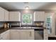 Bright kitchen with white cabinets, stainless steel appliances, and a window with a view at 3038 Penny Ln, Johns Island, SC 29455