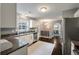 Bright kitchen features stainless steel appliances, white cabinetry, and dark hardwood floors at 3038 Penny Ln, Johns Island, SC 29455