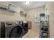 A functional laundry room with washer, dryer, shelving, and a window for ventilation at 3038 Penny Ln, Johns Island, SC 29455
