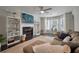 Inviting living room featuring a cozy fireplace, large windows, and hardwood flooring at 3038 Penny Ln, Johns Island, SC 29455