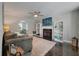 Comfortable living room showcasing a fireplace, hardwood floors, and view to dining area at 3038 Penny Ln, Johns Island, SC 29455