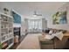 Bright and airy living room with fireplace, large windows, and hardwood floors at 3038 Penny Ln, Johns Island, SC 29455