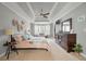Comfortable main bedroom with tray ceiling, sitting area and a large dark wood dresser at 3038 Penny Ln, Johns Island, SC 29455