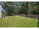 Large, grassy backyard with swing set and perimeter fence at 307 Wilderland Ct, Moncks Corner, SC 29461