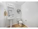 Modern half bath with hardwood floors, a pedestal sink, and decorative shelving at 307 Wilderland Ct, Moncks Corner, SC 29461