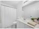Bright bathroom with a large mirror, white vanity, and shower with curtain at 307 Wilderland Ct, Moncks Corner, SC 29461