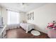 Bright bedroom with neutral walls, hardwood floors, and a large window with sheer curtains at 307 Wilderland Ct, Moncks Corner, SC 29461