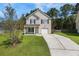 Charming two-story home with well-manicured lawn and inviting front porch at 307 Wilderland Ct, Moncks Corner, SC 29461