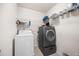 Functional laundry room featuring modern washer and dryer units with shelving at 307 Wilderland Ct, Moncks Corner, SC 29461