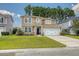 Traditional two-story home featuring mixed siding, a well-manicured lawn, and a two-car garage at 314 Sanctuary Park Dr, Summerville, SC 29486