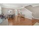 Bright living space featuring hardwood floors, stairs to upper level, and views of the kitchen at 314 Sanctuary Park Dr, Summerville, SC 29486