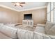 Comfortable living room with ceiling fan, soft couch, wood floors, and entertainment center with TV at 314 Sanctuary Park Dr, Summerville, SC 29486