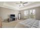 Main bedroom with carpeted floors, TV, ceiling fan, and windows letting in natural light, creating a cozy retreat at 314 Sanctuary Park Dr, Summerville, SC 29486
