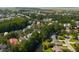 An aerial view shows the beautiful neighborhood surrounded by lush mature trees at 316 Bridgetown Pass, Mount Pleasant, SC 29464