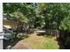 A lovely fenced backyard features a small table and is surrounded by lush landscaping at 316 Bridgetown Pass, Mount Pleasant, SC 29464