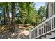 A lovely fenced backyard features a small table and is surrounded by lush landscaping at 316 Bridgetown Pass, Mount Pleasant, SC 29464