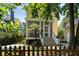 Rear view of home with screen porch, stairs, a fenced yard, and a mature palm tree at 316 Bridgetown Pass, Mount Pleasant, SC 29464