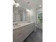 Bathroom with double sink vanity, large mirror, and ample counter space plus grey tile floor at 316 Bridgetown Pass, Mount Pleasant, SC 29464