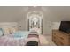 A charming bedroom with a tie-dye quilt, and double doors leading to another room at 316 Bridgetown Pass, Mount Pleasant, SC 29464