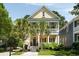 Charming two-story home with inviting porch, palm trees, and classic Southern style at 316 Bridgetown Pass, Mount Pleasant, SC 29464