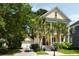 Charming two-story home with mature palms, covered front porch, and detached two-car garage at 316 Bridgetown Pass, Mount Pleasant, SC 29464
