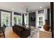 Comfortable living room featuring white trim, ceiling fan, and multiple windows at 316 Bridgetown Pass, Mount Pleasant, SC 29464