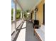 Covered porch with seating, ceiling fan, and white columns offers a relaxing outdoor space at 316 Bridgetown Pass, Mount Pleasant, SC 29464