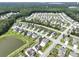 Serene aerial view of homes surrounding a pond, showcasing a harmonious blend of nature and residential living at 316 Knawl Rd, Moncks Corner, SC 29461
