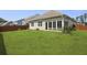 Expansive backyard featuring a well-manicured lawn and enclosed sunroom at 316 Knawl Rd, Moncks Corner, SC 29461