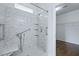 Accessible shower featuring marble tile, safety bars, and built-in shelves at 316 Knawl Rd, Moncks Corner, SC 29461