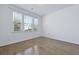 Light bedroom with hardwood floors and windows overlooking the neighborhood at 316 Knawl Rd, Moncks Corner, SC 29461
