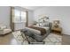 Staged primary bedroom showcases a bed, side tables, lamps, and scenic wall art at 316 Knawl Rd, Moncks Corner, SC 29461
