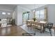 Virtually staged dining room with hardwood floors, modern table set, and sliding door to the patio at 316 Knawl Rd, Moncks Corner, SC 29461