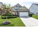 Lovely home with flowering tree in the front yard and well-kept landscaping at 316 Knawl Rd, Moncks Corner, SC 29461