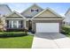 Well-manicured lawn in front of charming brick-accented home and attached garage at 316 Knawl Rd, Moncks Corner, SC 29461