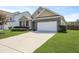 Charming home featuring a brick facade, two-car garage, and well-maintained landscaping at 316 Knawl Rd, Moncks Corner, SC 29461