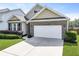 Well-maintained lawn and charming brick-accented home with an attached garage at 316 Knawl Rd, Moncks Corner, SC 29461