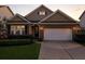 Evening shot of charming home with brick accents, garage, and manicured lawn at 316 Knawl Rd, Moncks Corner, SC 29461